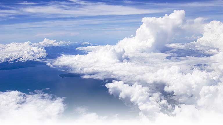 Deep blue sky and cumulous clouds from an aircraft.