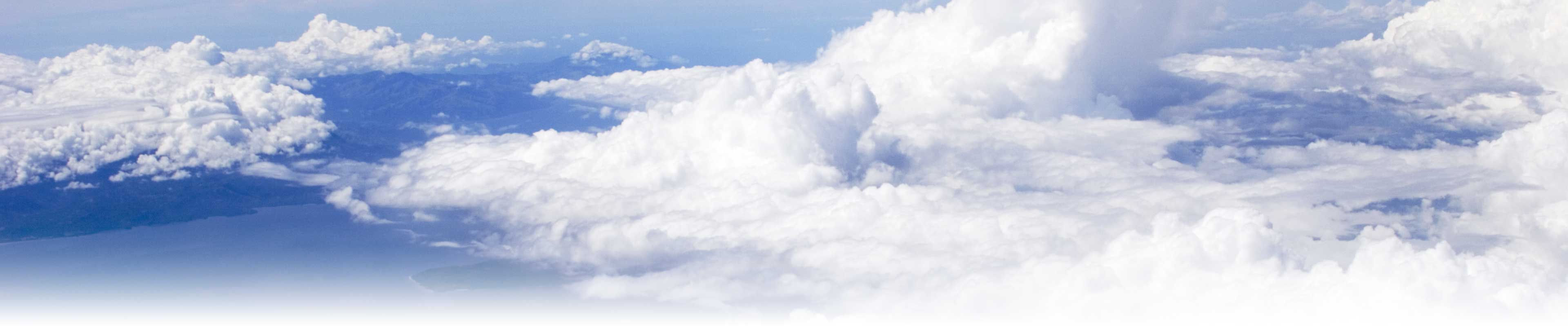 Deep blue sky and cumulous clouds from an aircraft.
