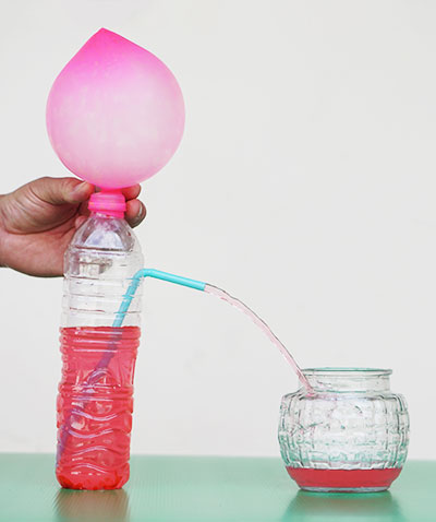 The water bottle experiment being done with red liquid.