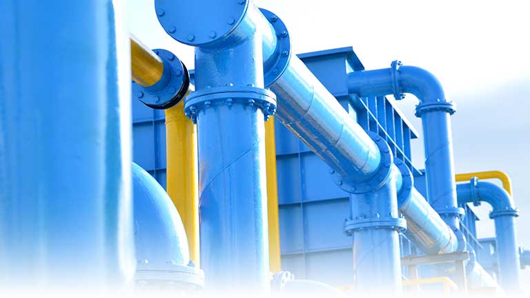 A modern water treatment plant with large, bright blue and yellow pipes.