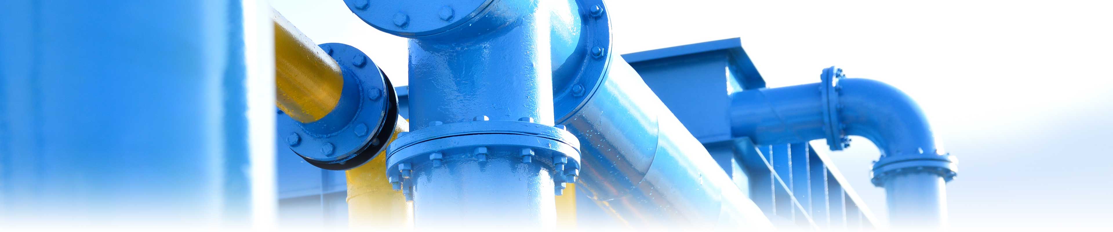 A modern water treatment plant with large, bright blue and yellow pipes.