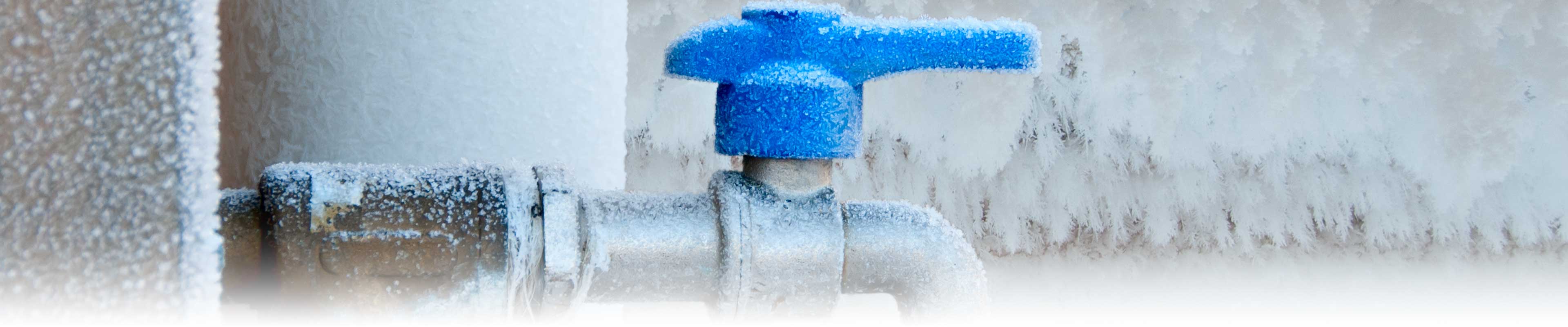 A frost covered outdoor water tap.