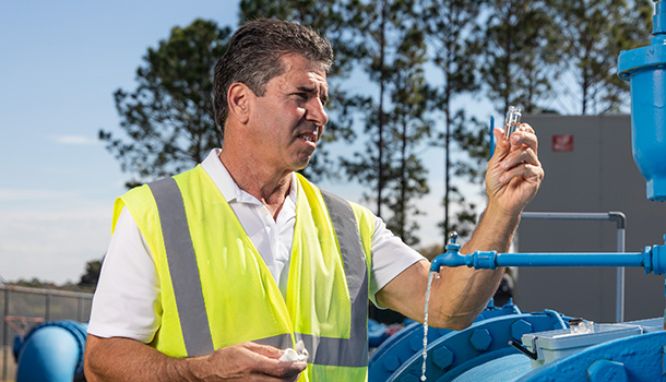 home-610x350-utility-worker-taking-water-sample